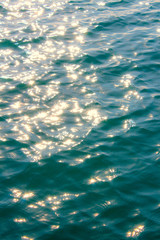 Black sea texture. Turquoise sea water with sun glare and ripple. Powerful and peaceful nature concept.
