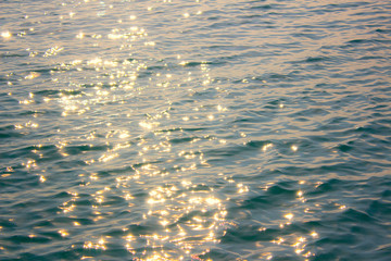 Black sea texture. Pastel colors sea water with sun glare and ripple. Powerful and peaceful nature...
