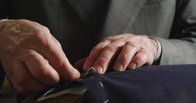 Tailoring. in ancient tradition of Italian tailors it is sewing a shirt . concept of tradition and Italian designer clothing.