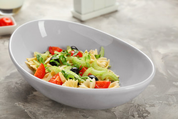 Tasty pasta salad with vegetables on table