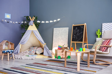 Modern room interior with play tent for child © New Africa