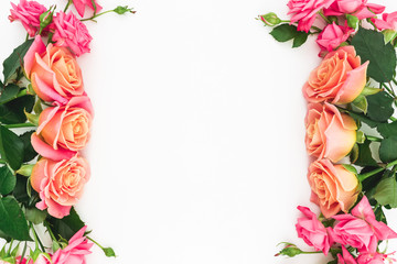 Floral frame made of roses, buds and green leaves on white background. Flat lay, top view. Spring background