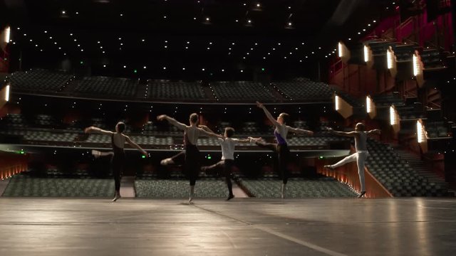 Group of young dancers rehearsing on stage.