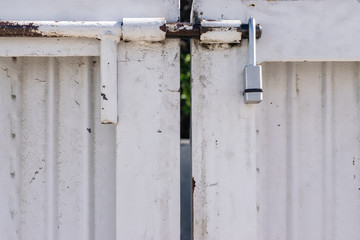 White gate entrance with slide latch and lock with room for copy text