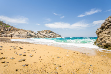 Beautiful sunny cozy holiday bay with big waves with crystal clear blue water sandy beach and a small laguna for sunbathing swimming or surfing, Ikaria Island, Nas Beach, Samos, Sporades, Greece