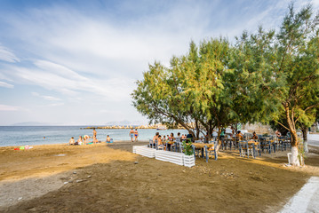 Beautiful sunny summer coast view to the greek blue sea with crystal clear water relaxing holiday beach perfect for sunbath at the shore or eating restaurant dinner, Therma, Ikaria, Sporades, Greece 
