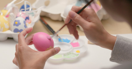 Painting colorful Easter egg