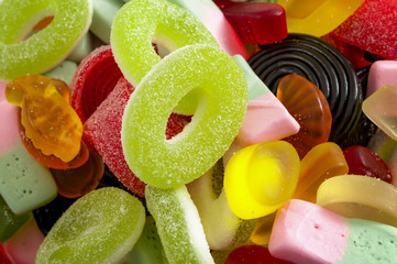 confectionery sweets and assorted lollies concept with close up of an assortment of gummy, colorful...