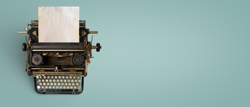 Vintage typewriter header with old paper. retro machine technology - top view and creative flat lay design.