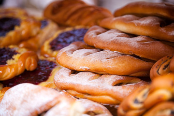Close-up of fresh delicious freshly cooked buns with berries in even rows
