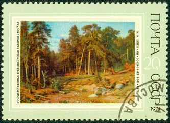 Ukraine - circa 2018: A postage stamp printed in USSR show painting by artist Shishkin Pine forest....