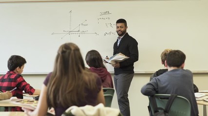 Medium shot of teacher holding math class - Powered by Adobe