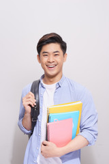 Obraz premium Confident asian handsome student holding books