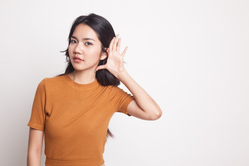 Beautiful young Asian woman listen to something.