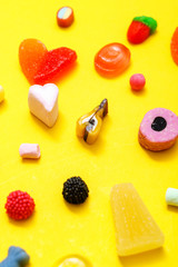 colorful candy on the yellow background