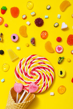 colorful candy on the yellow background