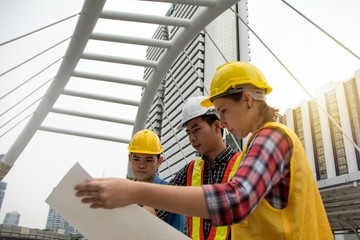 Team of Young Females and Male Engineers Working on Building projects