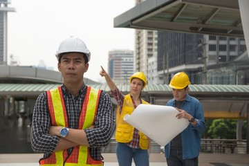 Team of architectures standing at construction site looking at progress.