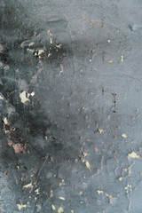 Old gray cracked paint on the cement wall