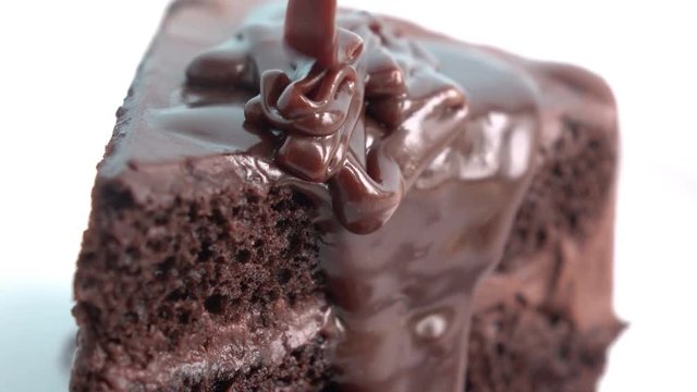 pouring chocolate on cake