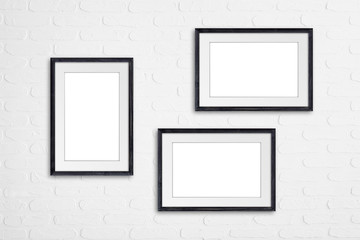 Frames on white bricks wall, interior decoration mock up	