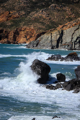 Waves hit a big rock near from the coastline. Seascape in the Portugal