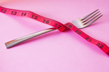 fork with tape measure. diet and slimming concept