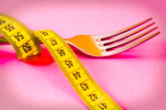 fork with tape measure. diet and slimming concept
