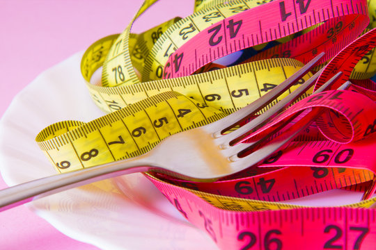 fork with tape measure. diet and slimming concept