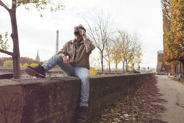 Fototapeta premium Modern guy using cellphone in the European city.