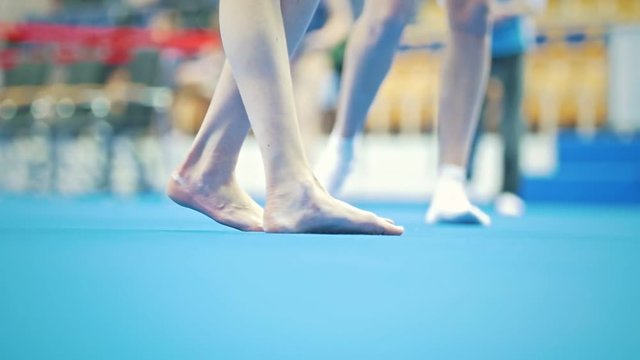 Feet of young woman gymnast competing at the stadium
