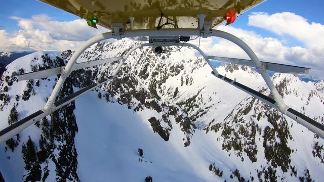 POV Mount Under Helicopter Flying High Speed Between Snowy Mountains in Pacific Northwest USA Intense Action Fast Motion Turns Closeup