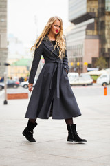 Fototapeta premium Portrait of a young beautiful woman in gray coat