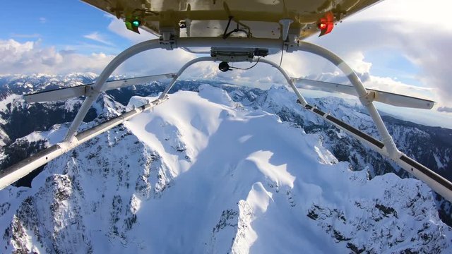 Winter Expedition Deep Into Mountainous Backcountry Flying Helicopter Reverse Skids View
