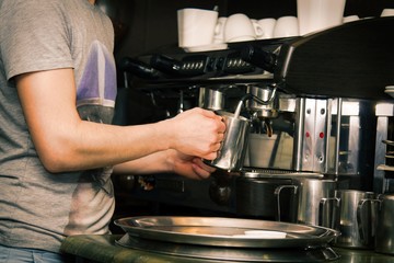 waiter preparing coffee at the bar