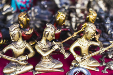 Colorful traditional buddhist souvenirs are sold on the tourist market in Kathmandu, Nepal. Contain of ornaments, small figures, jewelry, statues, masks, prayer whells.