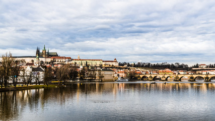 Fototapeta na wymiar Old Prague is reflected in the waters of the Vltava river