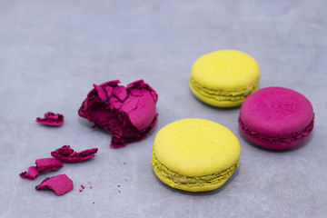 Macaroni cakes on a gray concrete background.