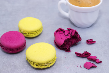 Macaroni cakes on a gray concrete background.