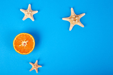Fototapeta na wymiar Summer concept. Orange fruit and starfish