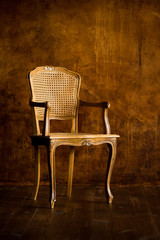 old chair on a brown wall background.