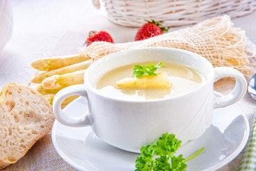 asparagus cream soup with capers and fresh baguette