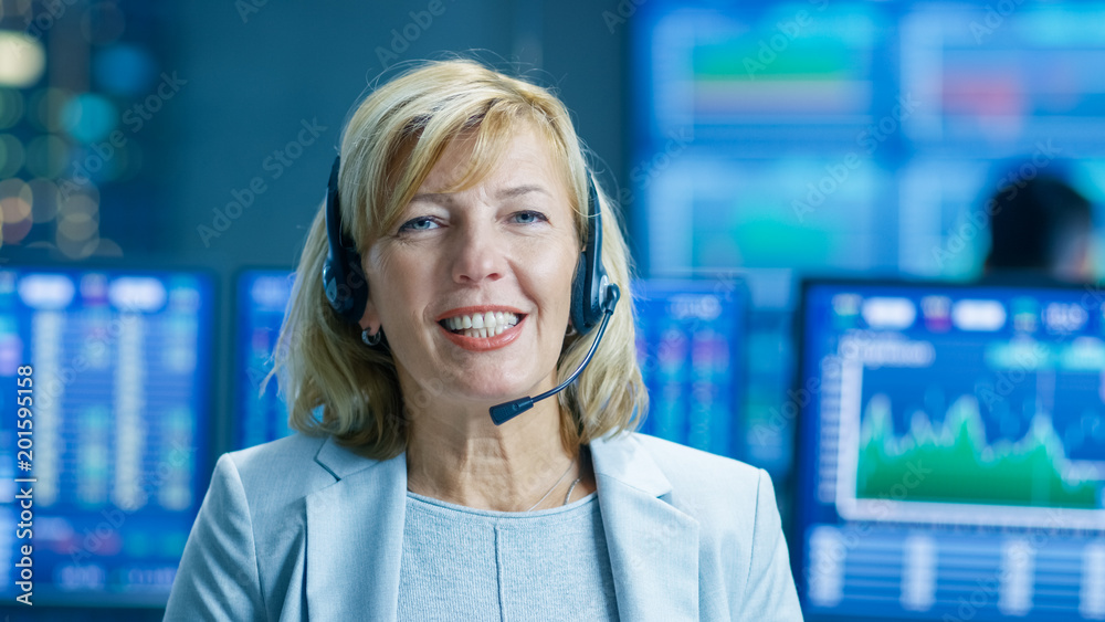 Poster chief sales force representative talks into the headset and looking into camera. behind her people w