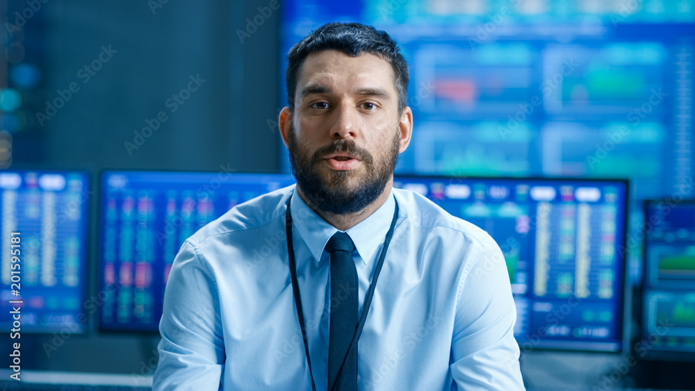 Poster Professional Stock Market Trader Charismatically Talks into the Camera. Behind Him Computer Screens with Ticker Numbers, Data, Graphs.