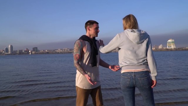The girl tries to escape from her boyfriend, but he does not let her go