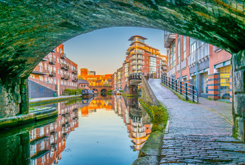 Sunset view of brick buildings alongside a water channel in the central Birmingham, England - obrazy, fototapety, plakaty