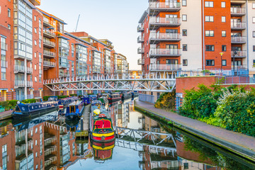Sunset view of brick buildings alongside a water channel in the central Birmingham, England © dudlajzov