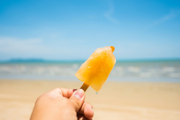 Yellow ice cream stands on the beach in summer.