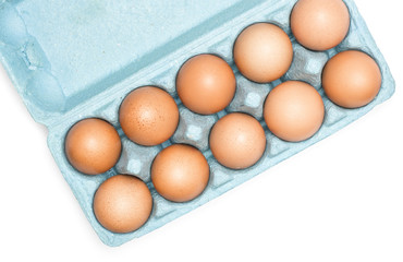 Brown chicken eggs in a blue carton box top view isolated on white background set of ten.