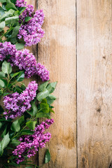 lilac branches on a wooden background, blooming lilacs, old boards, postcard, spring